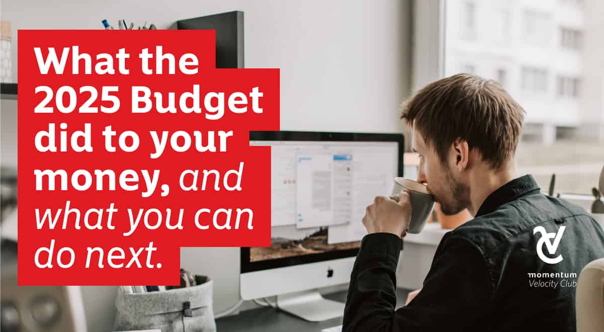 A young male professional looking at the computer screen reviewing the National Budget while having a cup of coffee. 