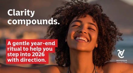 A young woman smiling confidently on a summer beach holiday, reflecting on the year and looking ahead to 2026.