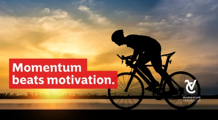 A man riding his bicycle, confident that steady momentum is the key to building long-term wealth.