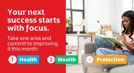 A woman sits on her sofa with a notebook, writing down her long-term financial goals.